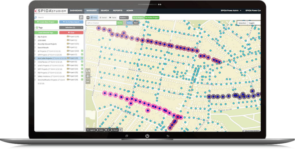 A laptop screen showcases the SPIDA®calc software interface, with a map marked by purple and blue dots. These represent various data points across a neighborhood layout, designed to optimize grid infrastructure effectively.